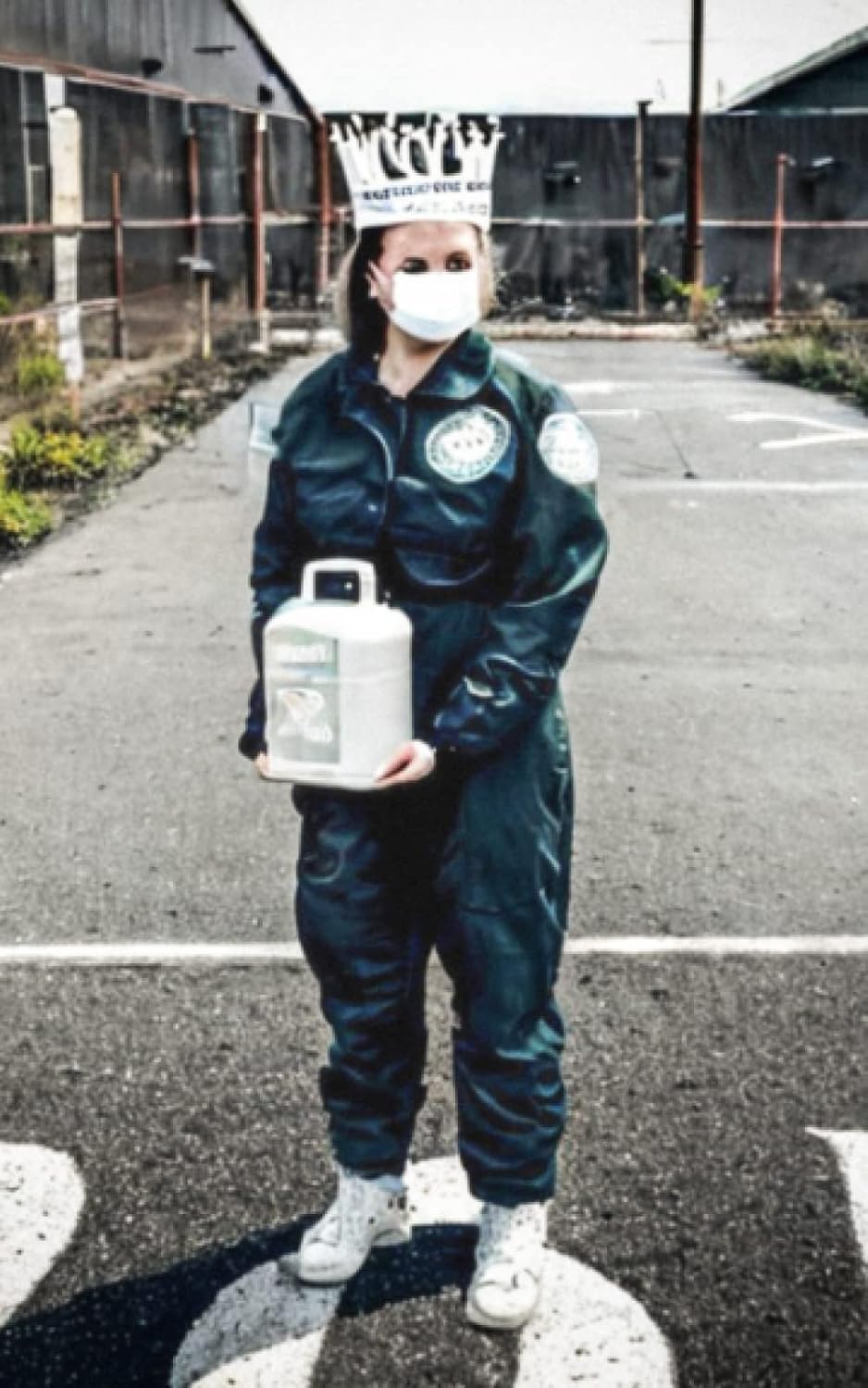 A person holding a gas canister in an urban setting